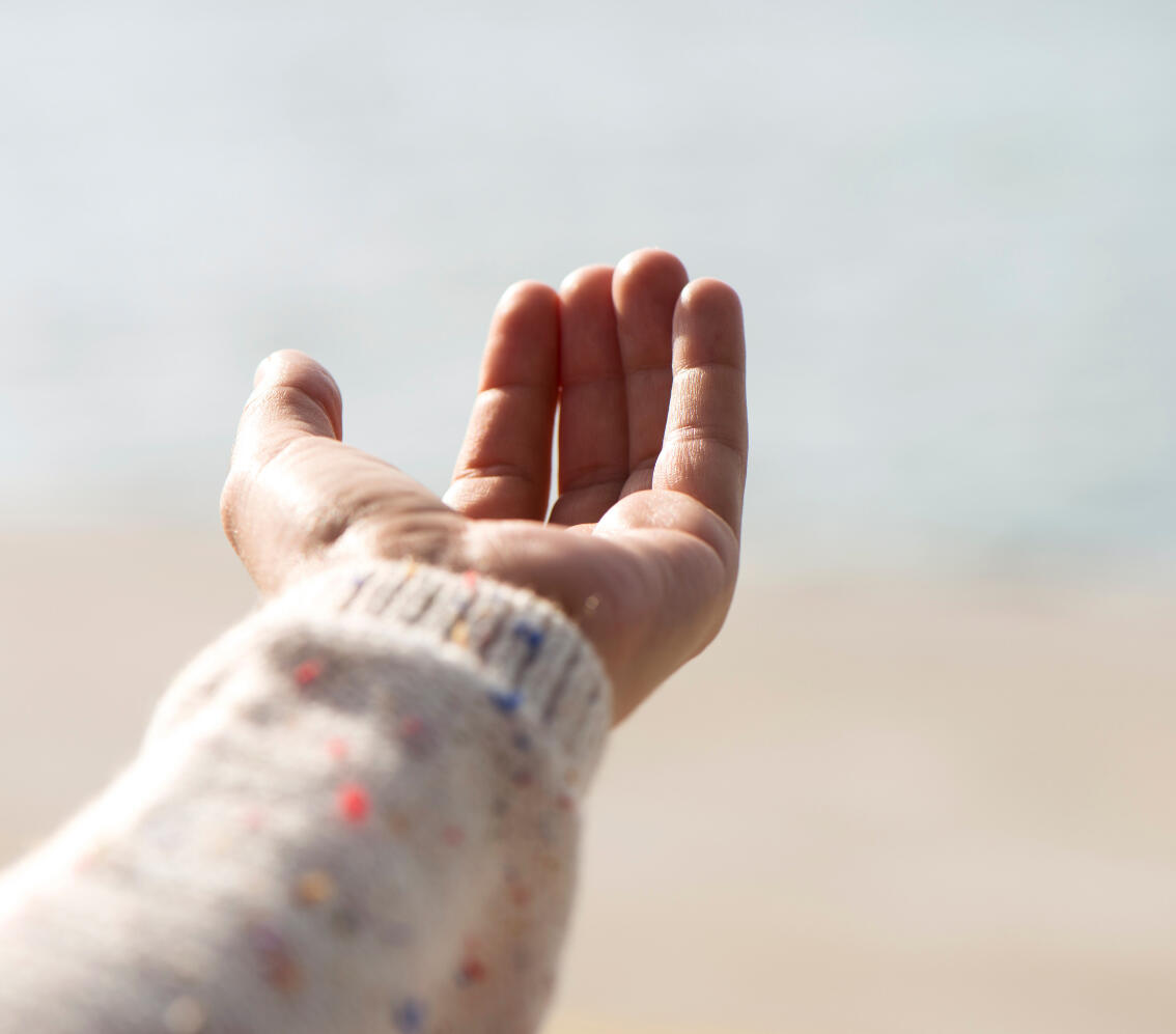 Outstretched hand offering healing and nervous system regulation through SoulPosture™ methods